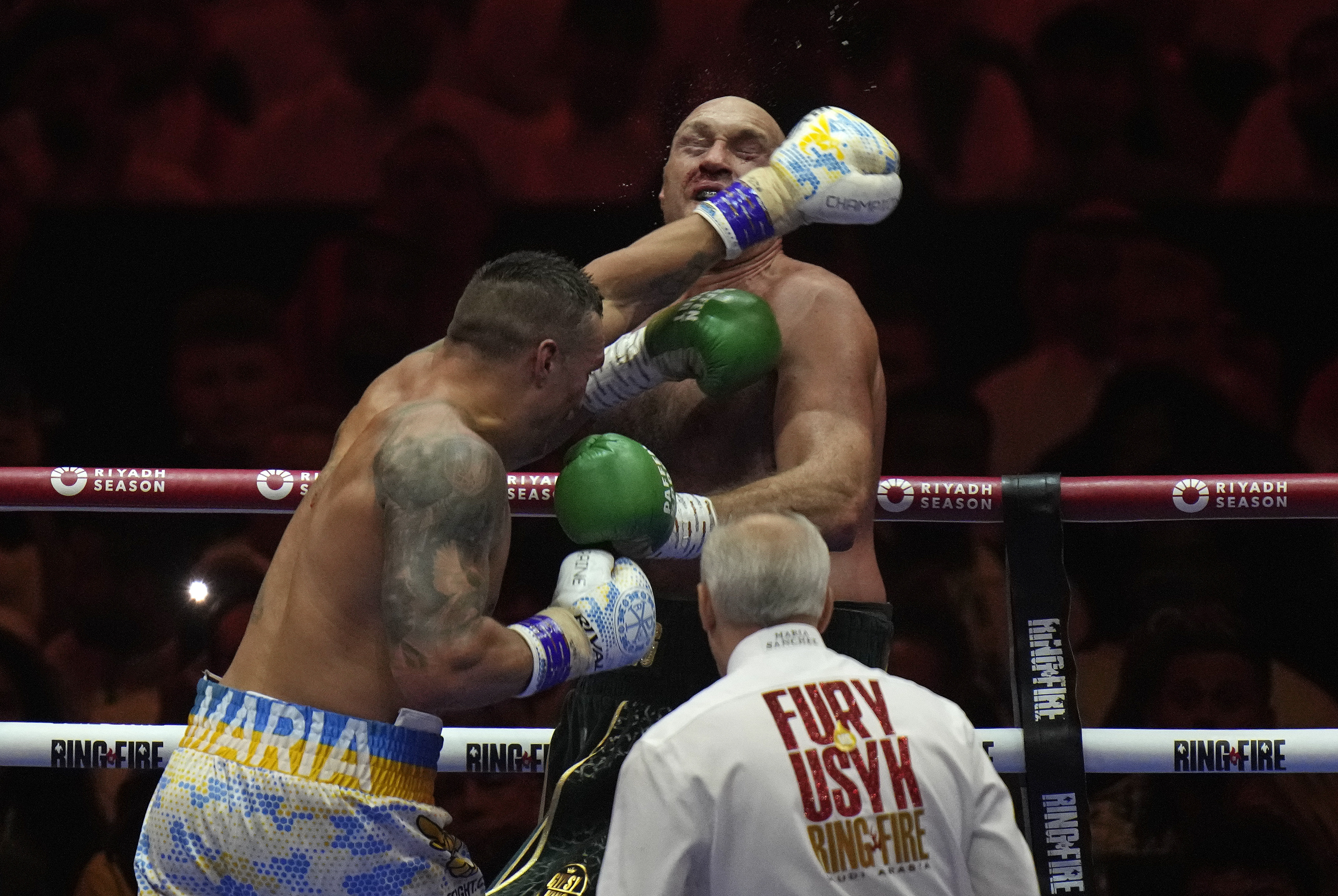 FILE - Britain's Tyson Fury, rear, takes a blow from Ukraine's Oleksandr Usyk during their undisputed heavyweight world championship boxing fight at the Kingdom Arena in Riyadh, Saudi Arabia, Sunday, May 19, 2024. The photo was part of a series of images by photographer Francisco Seco which won the Thomas V. diLustro best portfolio award for 2024 given out by the Associated Press Sports Editors during their annual winter meeting. 