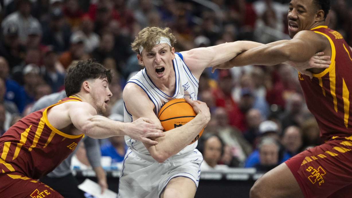 Brigham Young Cougars forward Richie Saunders (15) drives through Iowa State Cyclones center Dishon Jackson (1) and guard Nate Heise (0) during a quarterfinals game at the Big 12 Championship at the T-Mobile Center in Kansas City, Missouri, on Thursday, March 13, 2025.