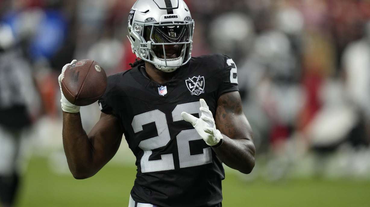 FILE - Las Vegas Raiders running back Alexander Mattison (22) warms up before an NFL football game against the Kansas City Chiefs, Oct. 27, 2024, in Las Vegas.