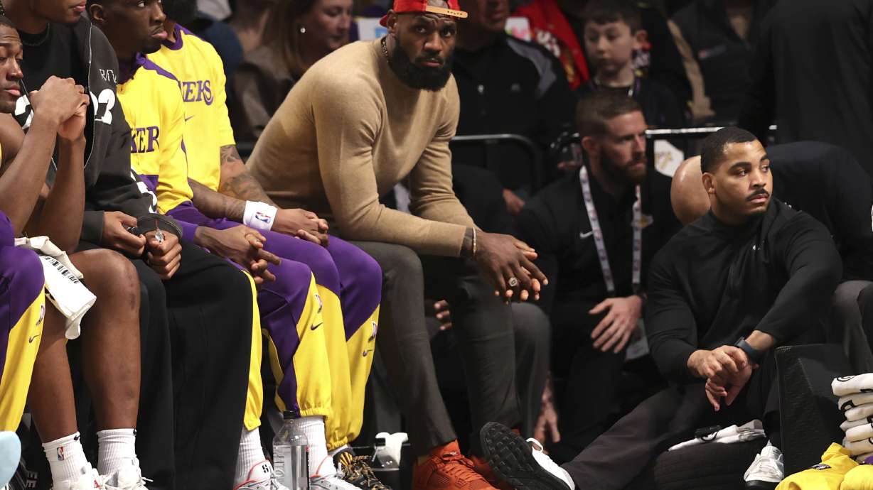 Los Angeles Lakers' LeBron James, center, sits on the bench during the second half of an NBA basketball game against the Brooklyn Nets, Monday, March 10, 2025, in New York.