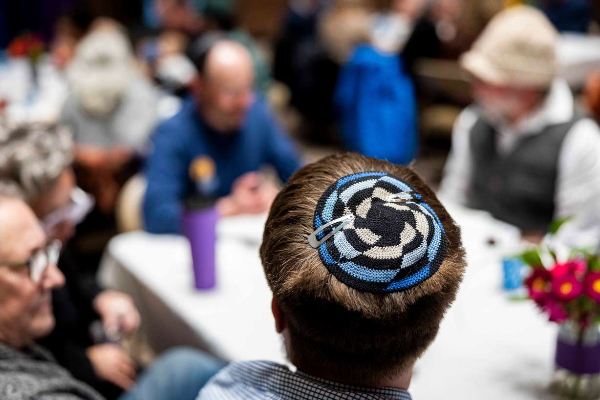 Rabbi Samuel Spector wears a kippah, also known as a yarmulke, as he talks with others during Shabbat dinner held at Congregation Kol Ami in Salt Lake City on Feb. 28.