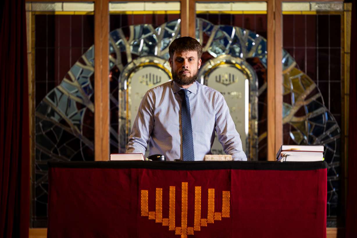 Rabbi Samuel Spector poses for a portrait inside the sanctuary with the ark, the cabinet in which the Torah scrolls are stored, standing behind him at Congregation Kol Ami in Salt Lake City on Feb. 28.