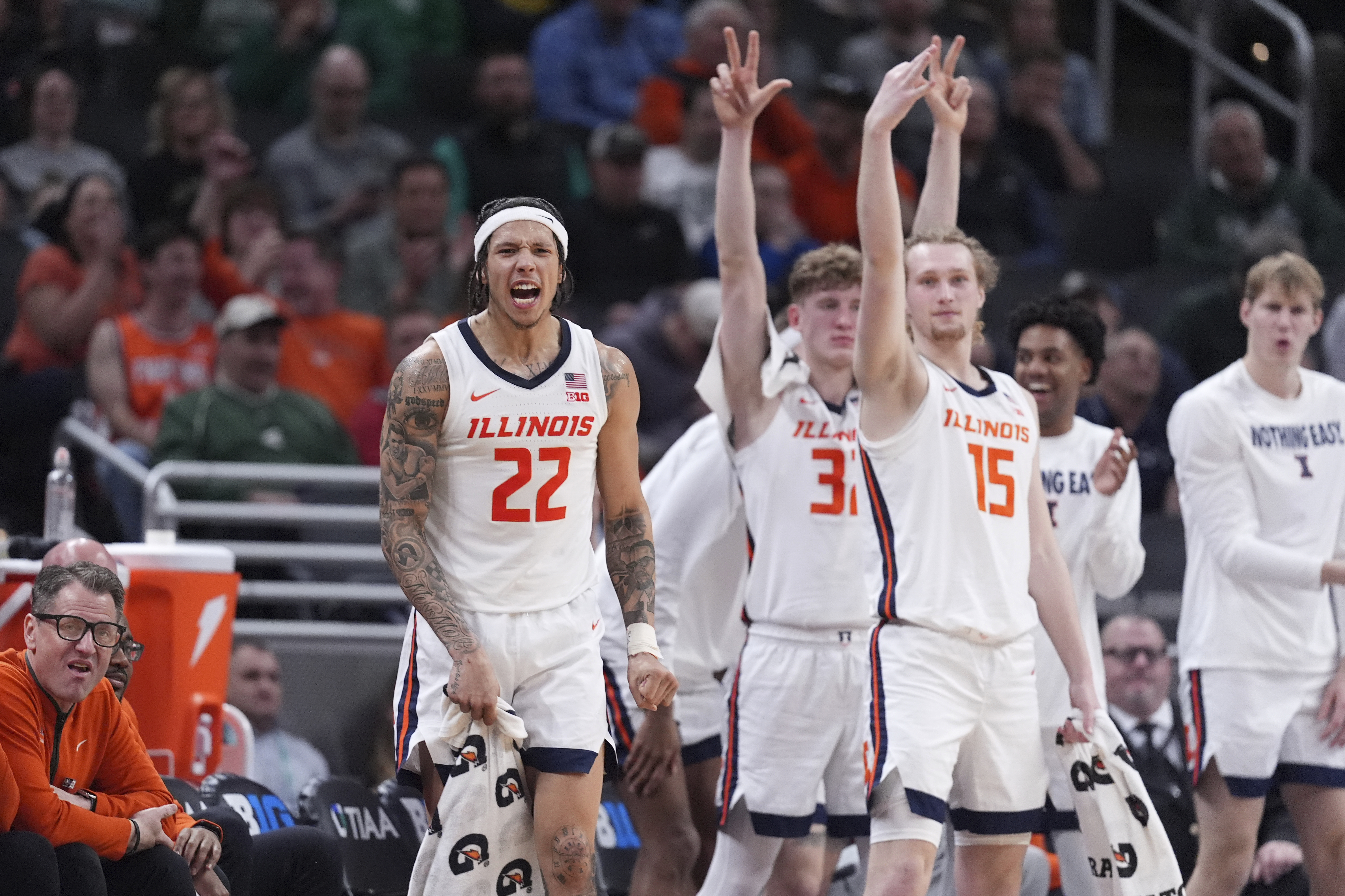 Illinois guard Tre White (22), Kasparas Jakucionis (32) and Jake Davis (15) react on the bench against Iowa during the second half of an NCAA college basketball game in the second round of the Big Ten Conference tournament in Indianapolis, Thursday, March 13, 2025.