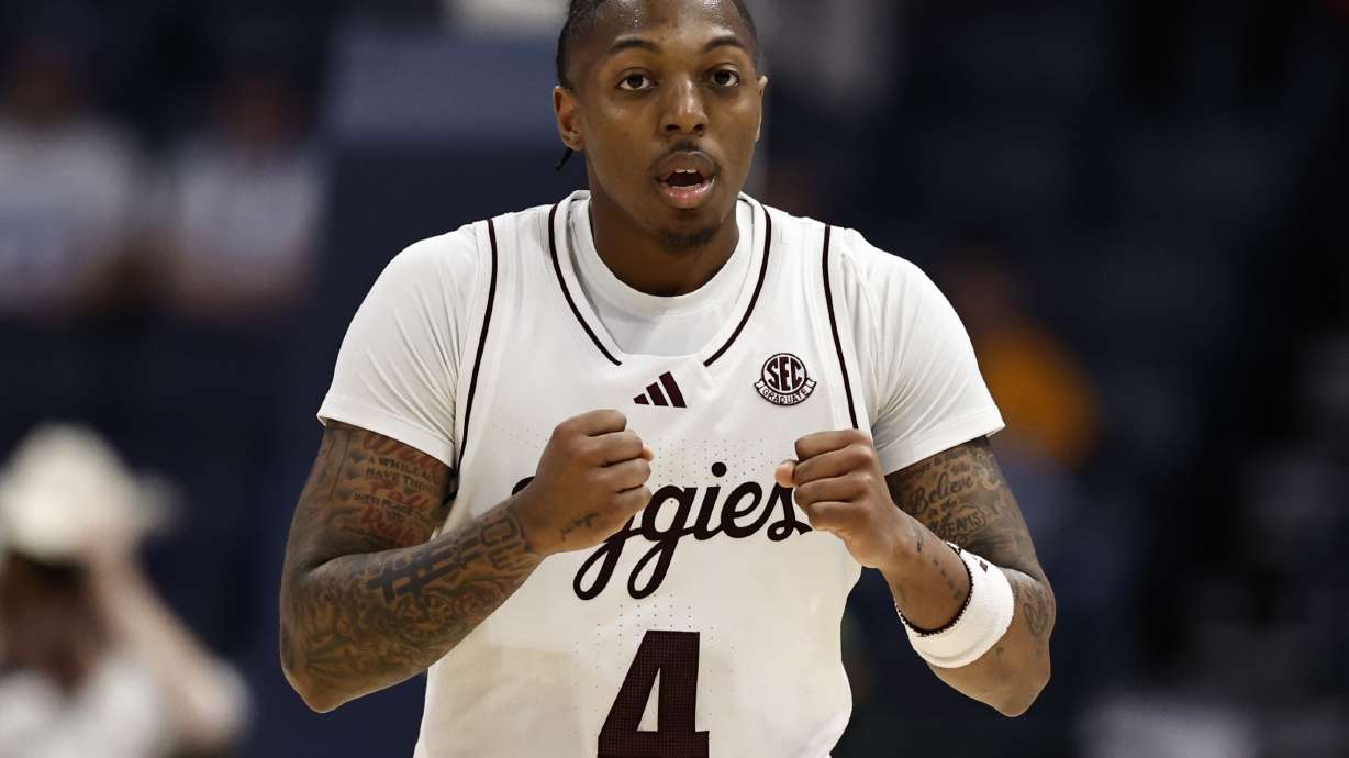 Texas A&M guard Wade Taylor IV (4) reacts ti his three-point shot against Texas during the second half of an NCAA college basketball game in the second round of the Southeastern Conference tournament, Thursday, March 13, 2025, in Nashville, Tenn.