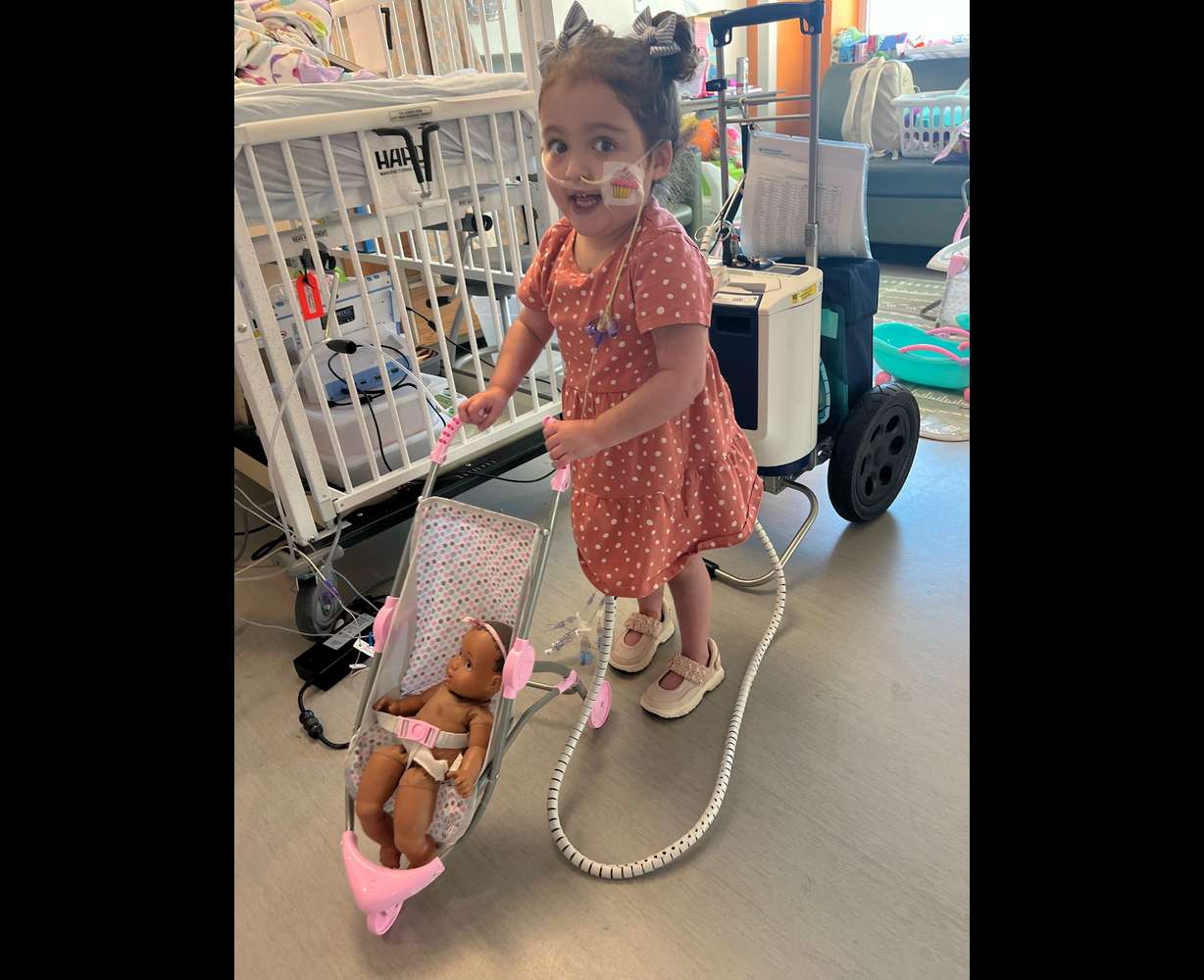 Sienna Barton, 4, pushes a doll in a stroller at Primary Children's Hospital. She is one of the first heart patients to participate in the cardiac rehab program.