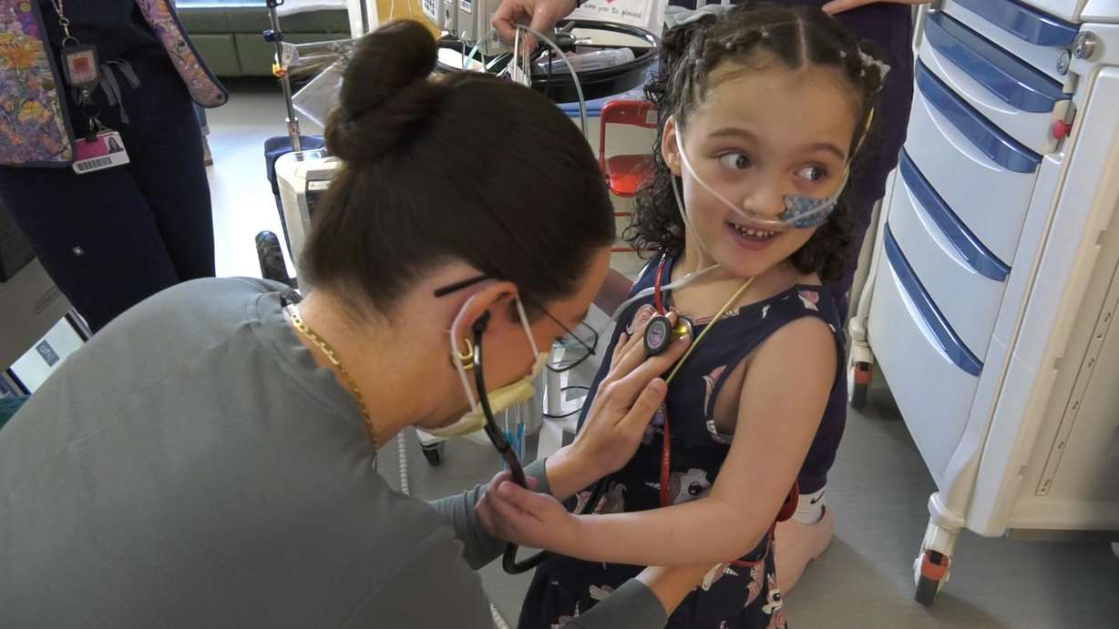 A health care provider checks Sienna Barton's heart at Primary Children's Hospital. She is one of the first heart patients to participate in the cardiac rehab program.