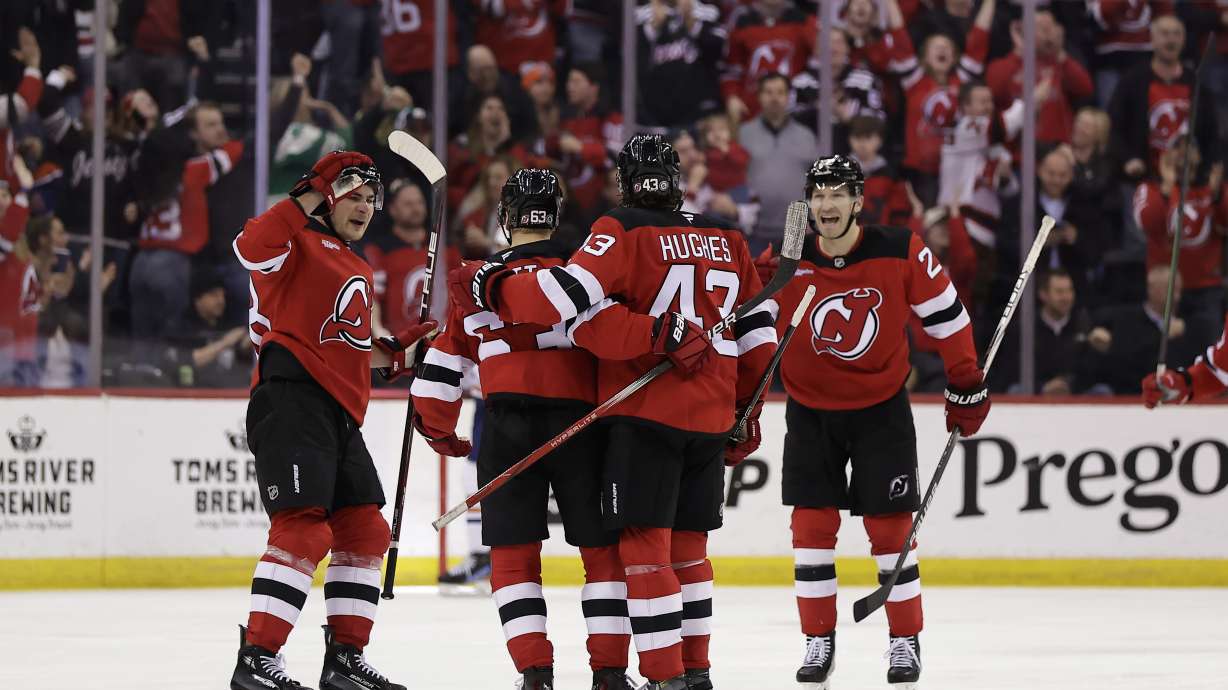 New Jersey Devils left wing Jesper Bratt (63) is congratulated by teammates after scoring during the third period of an NHL hockey game against the Edmonton Oilers, Thursday, March 13, 2025, in Newark, N.J.