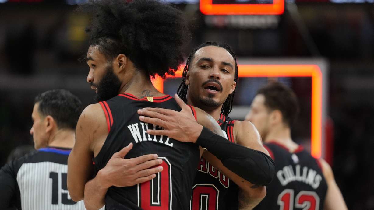 Chicago Bulls guard Tre Jones (30), right, and guard Coby White (0) celebrate their team's win over the Brooklyn Nets in an NBA basketball game Thursday, March 13, 2025, in Chicago.