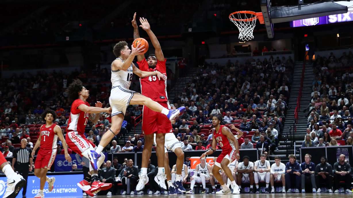 Utah State's Mason Falslev drives to the basket around a UNLV defender in the quarterfinal round of the Mountain West Tournament in Las Vegas.