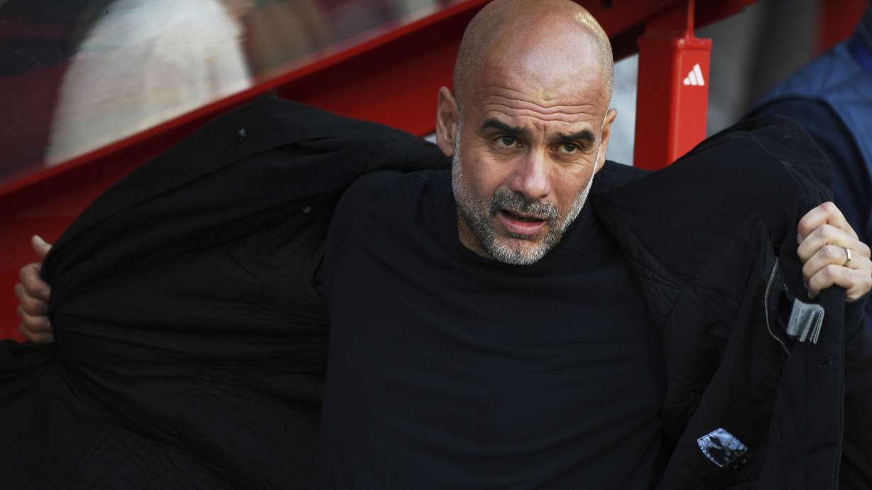 Manchester City's head coach Pep Guardiola arrives the bench prior to the English Premier League soccer match between Nottingham Forest and Manchester City at the City Ground stadium in Nottingham, England, Saturday, March 8, 2025.