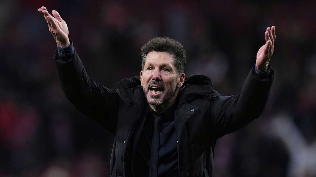Atletico Madrid's head coach Diego Simeone gestures while players applaud fans at the end of the Champions League round of 16, second leg, soccer match between Atletico Madrid and Real Madrid at the Metropolitano stadium in Madrid, Spain, Wednesday, March 12, 2025.