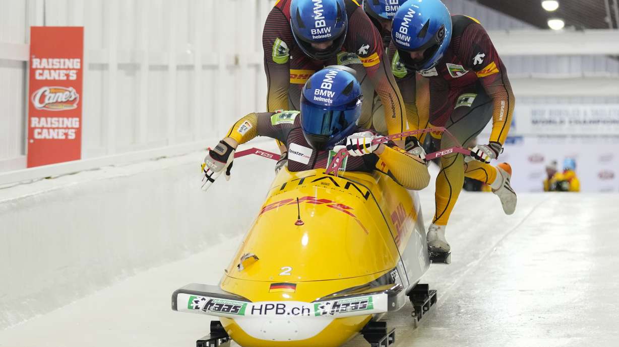Germany's Johannes Lochner, Florian Bauer, Jörn Wenzel and Georg Fleischhauer load their sled at the start of the second run of the 4-man bobsled race during the bobsled world championships, Friday, March 14, 2025, in Lake Placid, N.Y.