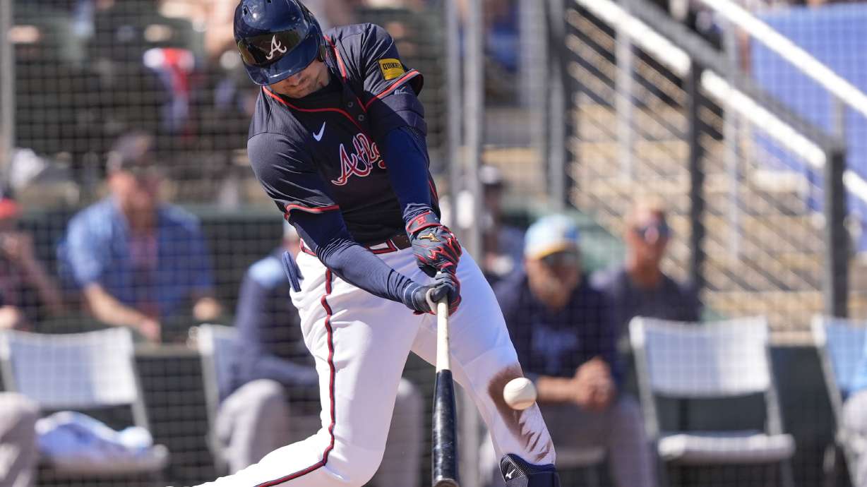 Atlanta Braves Austin Riley lines out to advance a runner to third base in the third inning of a spring training baseball game against the Tampa Bay Rays in North Port, Fla., Sunday, Feb. 23, 2025.