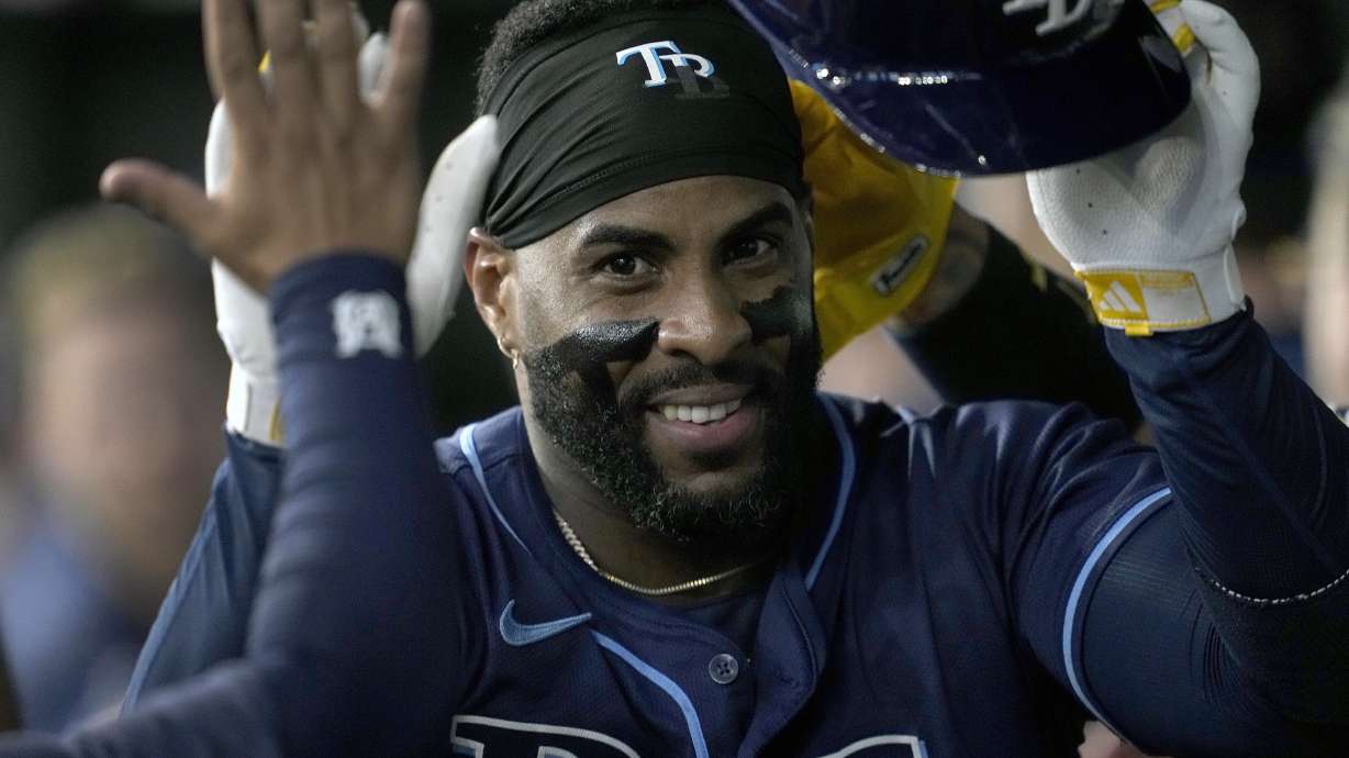 FILE - Tampa Bay Rays' Yandy Diaz celebrates in the dugout after hitting a three-run home run in the seventh inning of a baseball game against the Texas Rangers in Arlington, Texas, Saturday, July 6, 2024.