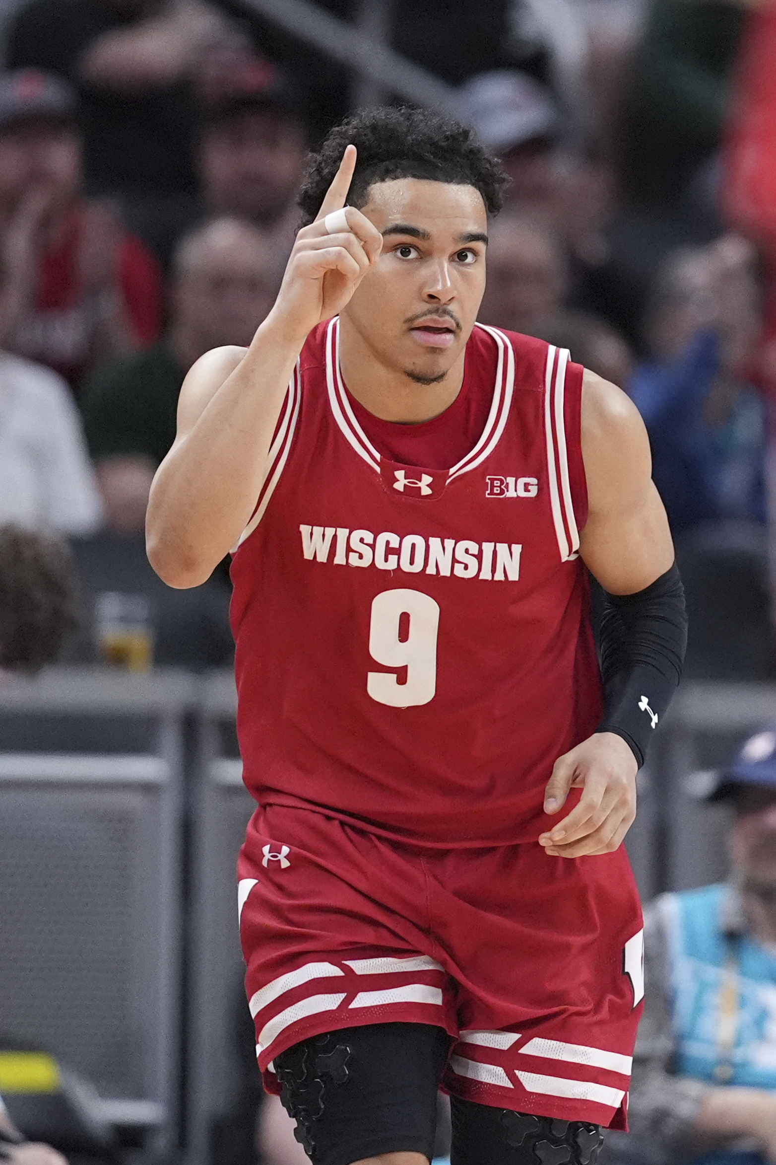 Wisconsin guard John Tonje (9) reacts to a basket against UCLA during the first half of an NCAA college basketball game in the quarterfinals of the Big Ten Conference tournament in Indianapolis, Friday, March 14, 2025. 