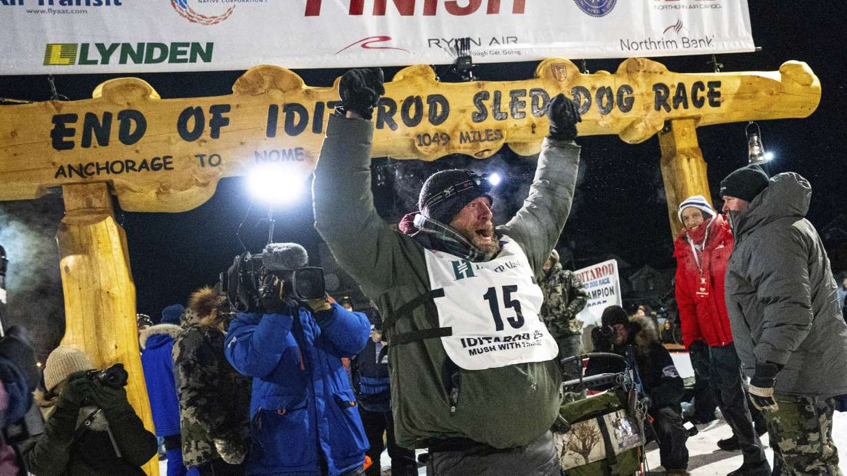 Jessie Holmes celebrates after winning the Iditarod Trail Sled Dog Race early Friday morning, March 14, 2025 in Nome.