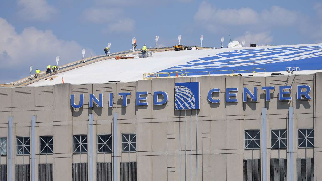 Workers are seen on the roof of the United Center in preparation for the 2024 Democratic National Convention in Chicago, Aug. 13, 2024.