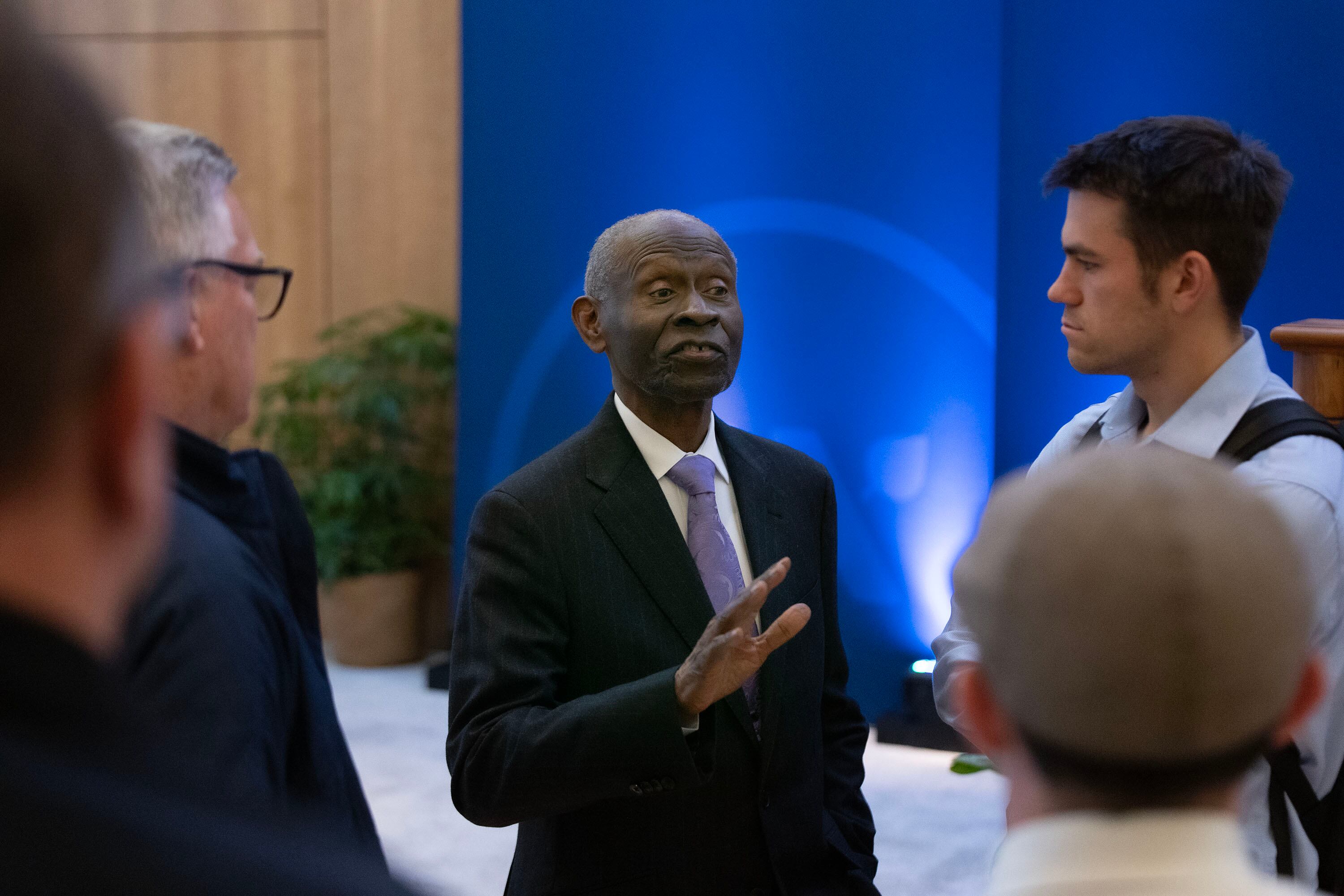 BYU student Oliver Nilsson, right, and others speak with Dr. Lawrence E. Carter at the Hinckley Center Assembly Hall at BYU in Provo on Thursday.