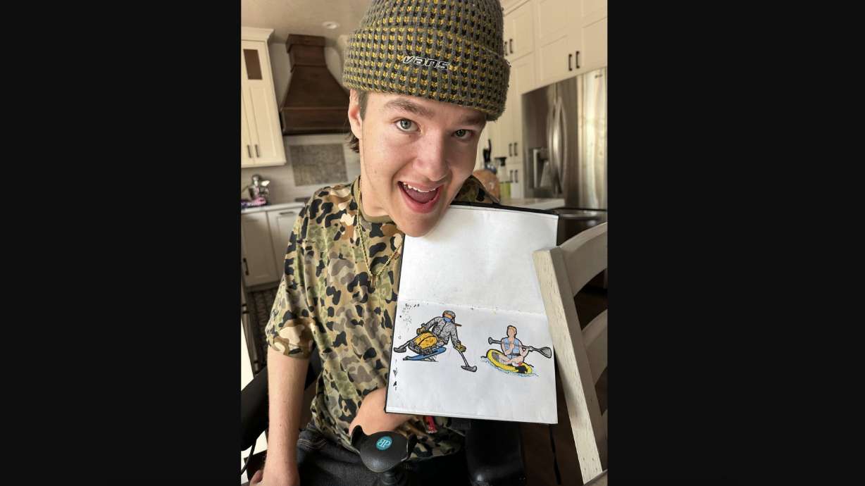 Jonah Bradshaw, 19, of Saratoga Springs shows off his drawings he created with his mouth. Participants at this year's HGGC Steve Young Ski Classic will each receive a goggle cover featuring Bradshaw's designs.