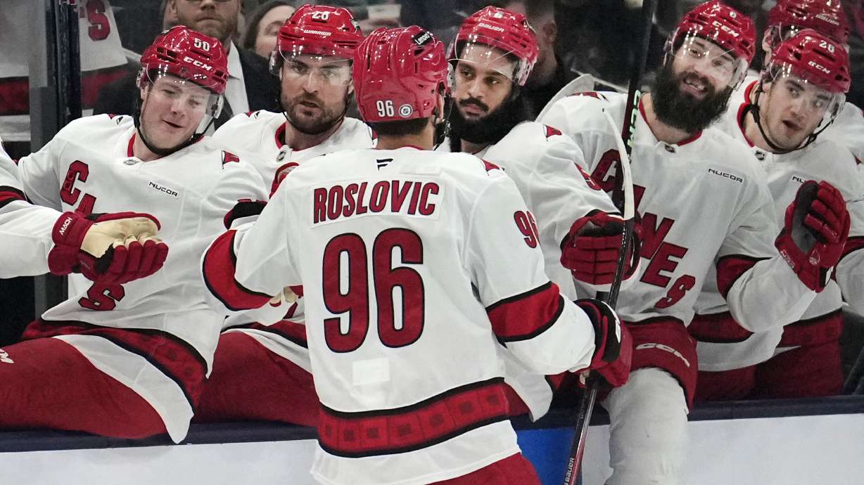 FILE - Carolina Hurricanes center Jack Roslovic (96) is congratulated by teammates following his goal in the first period of an NHL hockey game against the Columbus Blue Jackets in Columbus, Saturday, Nov. 23, 2024.