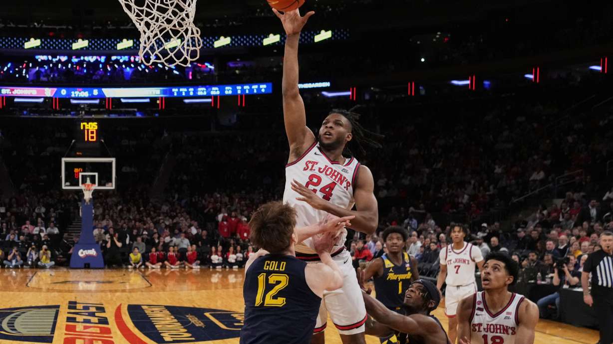 St. John's's Zuby Ejiofor (24) shoots over Marquette's Ben Gold (12) during the first half of an NCAA college basketball game in the semifinals of the Big East tournament Friday, March 14, 2025, in New York.