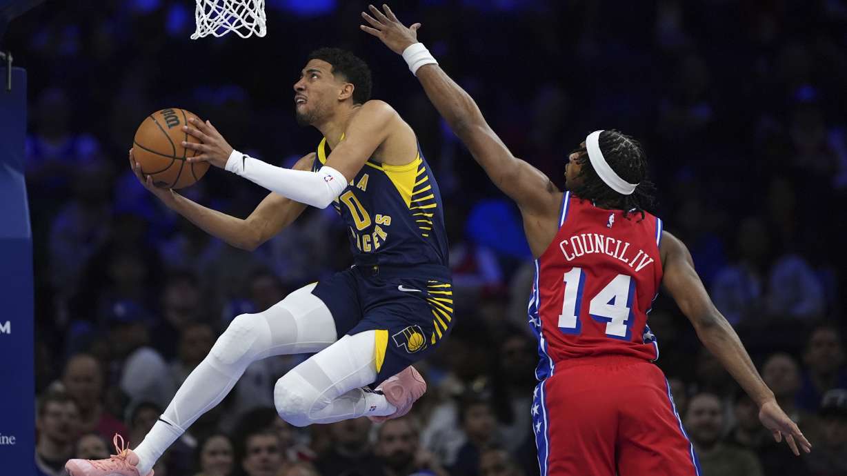 Indiana Pacers' Tyrese Haliburton, left, goes up for a shot agaist Philadelphia 76ers' Ricky Council IV during the first half of an NBA basketball game Friday, March 14, 2025, in Philadelphia.