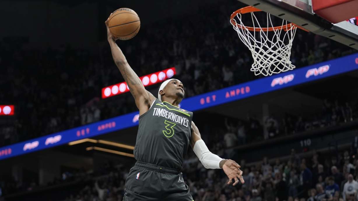 Minnesota Timberwolves forward Jaden McDaniels goes up for a dunk during the second half of an NBA basketball game against the Orlando Magic, Friday, March 14, 2025, in Minneapolis.