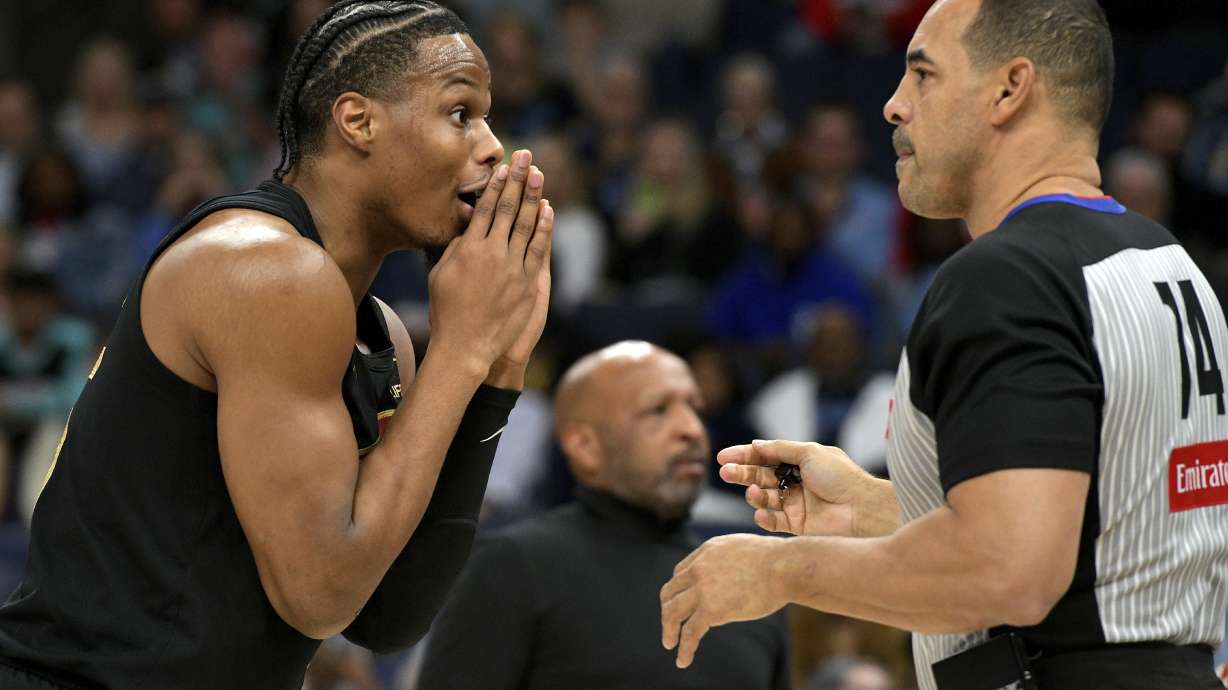 Cleveland Cavaliers forward Isaac Okoro, left, reacts to a call by referee Curtis Blair (74) in the first half of an NBA basketball game against the Memphis Grizzlies, Friday, March 14, 2025, in Memphis, Tenn.