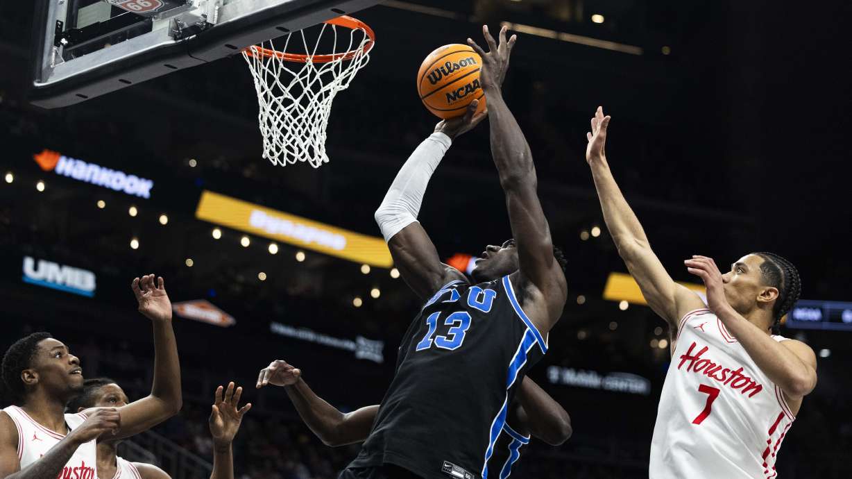 Brigham Young Cougars center Keba Keita (13) puts up a shot during a Big 12 Championship semifinal game between BYU and the Houston Cougars at the T-Mobile Center in Kansas City, Missouri, on Friday, March 14, 2025. The Houston Cougars claimed victory over BYU with a final score of 74-54, knocking BYU out of the Big 12 Championship.
