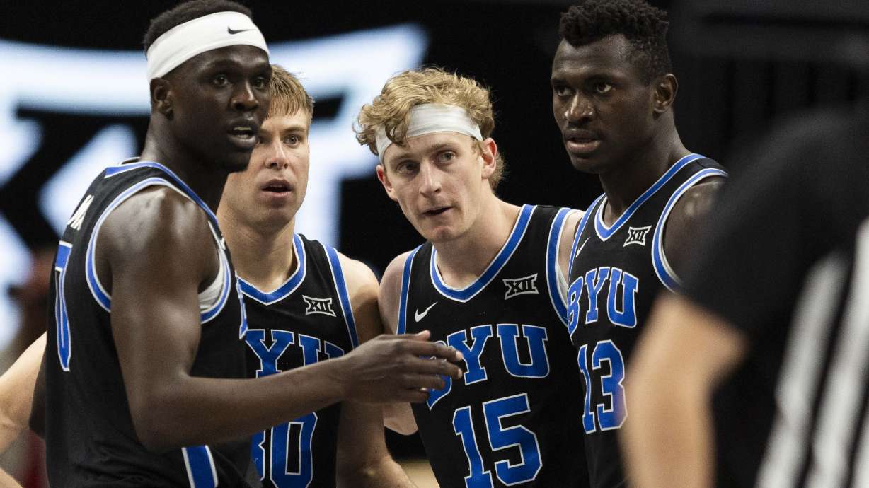 Brigham Young Cougars forward Mawot Mag (0), guard Dallin Hall (30), forward Richie Saunders (15) and center Keba Keita (13) all huddle together while they wait on a referee call during a Big 12 Championship semifinal game between BYU and the Houston Cougars at the T-Mobile Center in Kansas City, Missouri, on Friday, March 14, 2025.