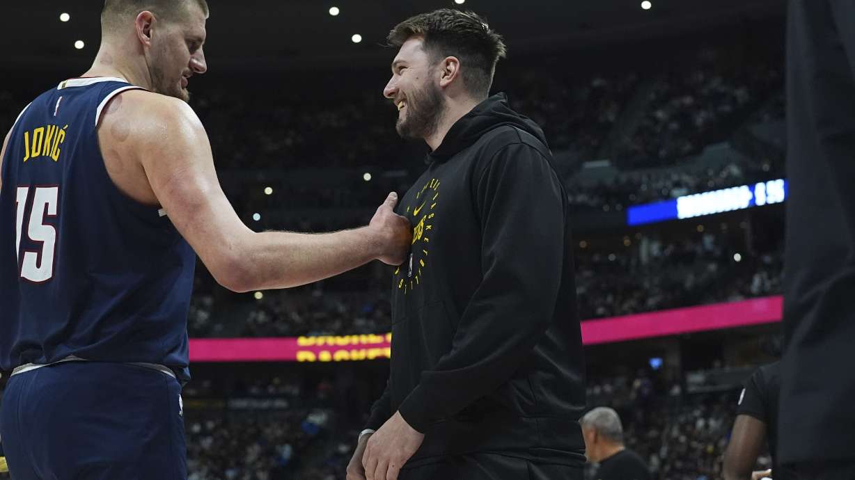 Denver Nuggets center Nikola Jokic, left, greets Los Angeles Lakers guard Luka Doncic, right, in the first half of an NBA basketball game Friday, March 14, 2025, in Denver.