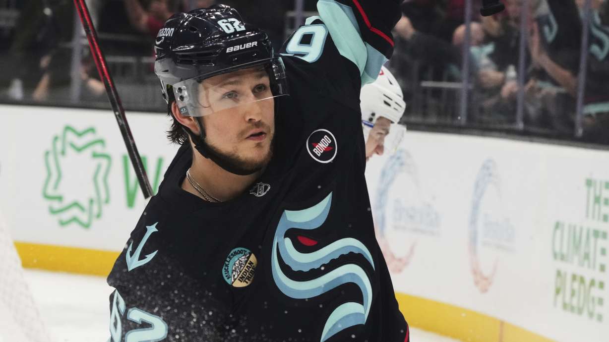 Seattle Kraken defenseman Brandon Montour celebrates scoring a goal for a 5-4 win in overtime against the Montreal Canadiens in an NHL hockey game Wednesday, March 12, 2025, in Seattle.