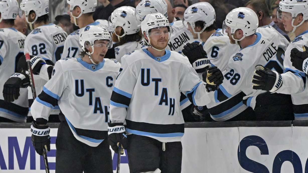Utah Hockey Club center Barrett Hayton, right, and center Clayton Keller are congratulated after a goal during the second period of an NHL hockey game against the Los Angeles Kings, Saturday, Feb. 22, 2025, in Los Angeles.