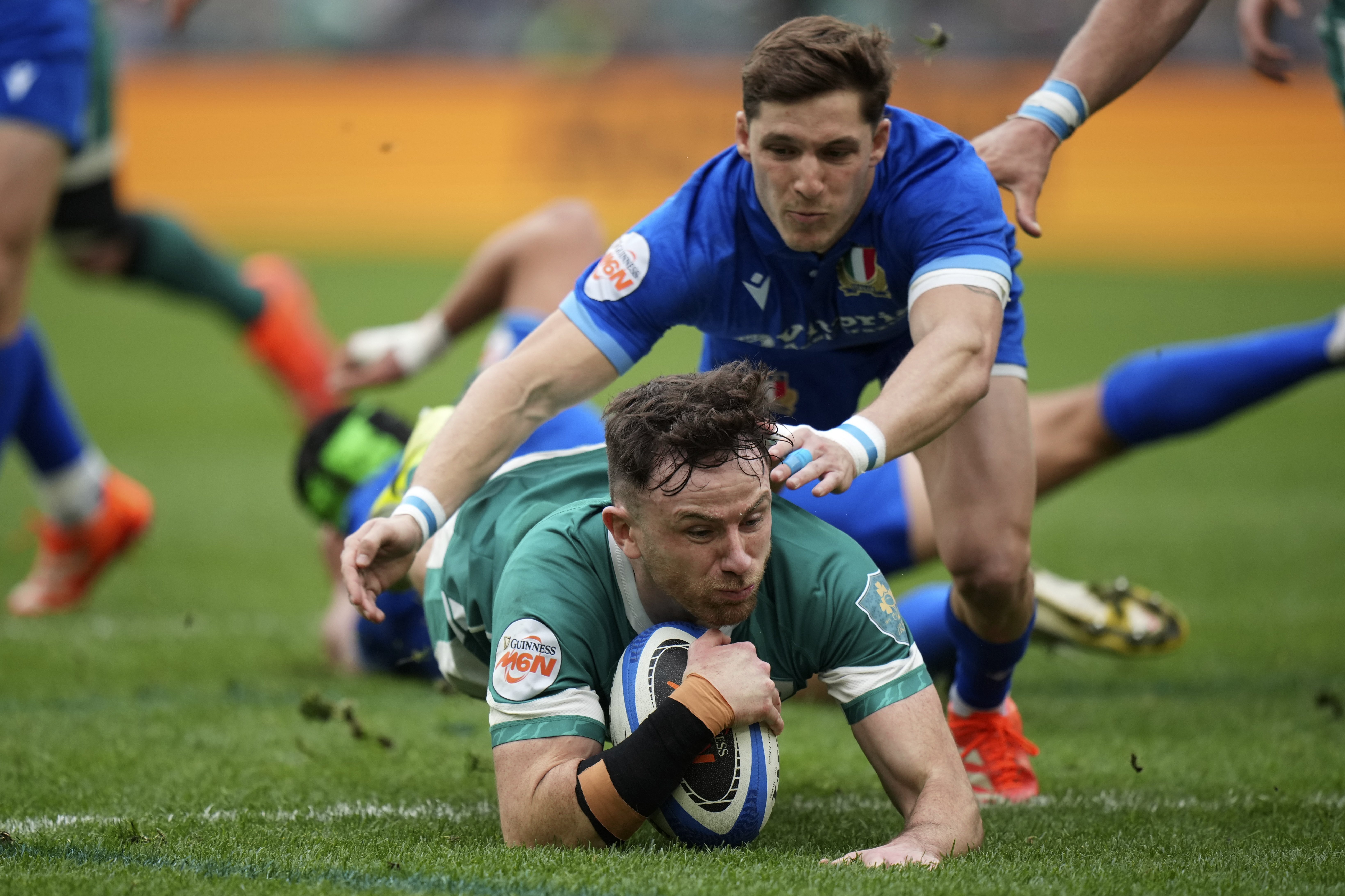 Ireland's Hugo Keenan, left, score a try as Italy's Martin Page-Relo tries to defend during the Six Nations rugby match between Italy and Ireland, at Rome's Olympic Stadium, Saturday, March 15, 2025. 