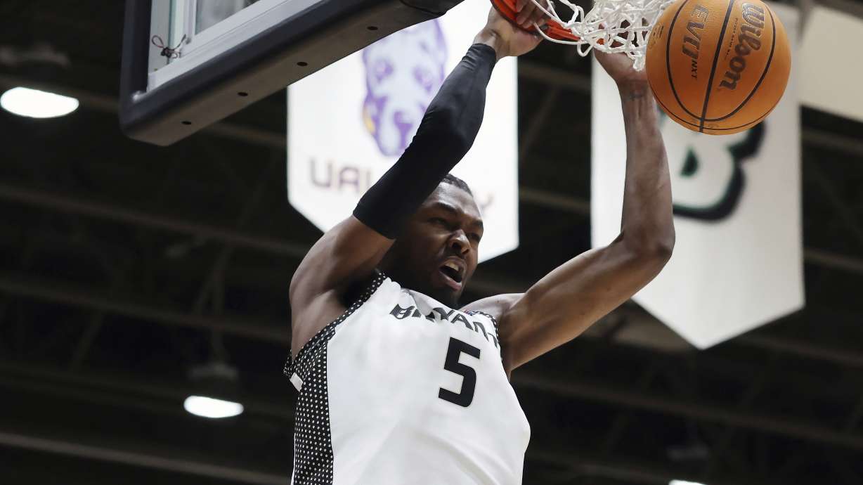 Bryant forward Barry Evans dunks during the first half of an NCAA college basketball game against Maine in the championship of the America East Conference tournament, Saturday, March 15, 2025, in Smithfield, R.I.