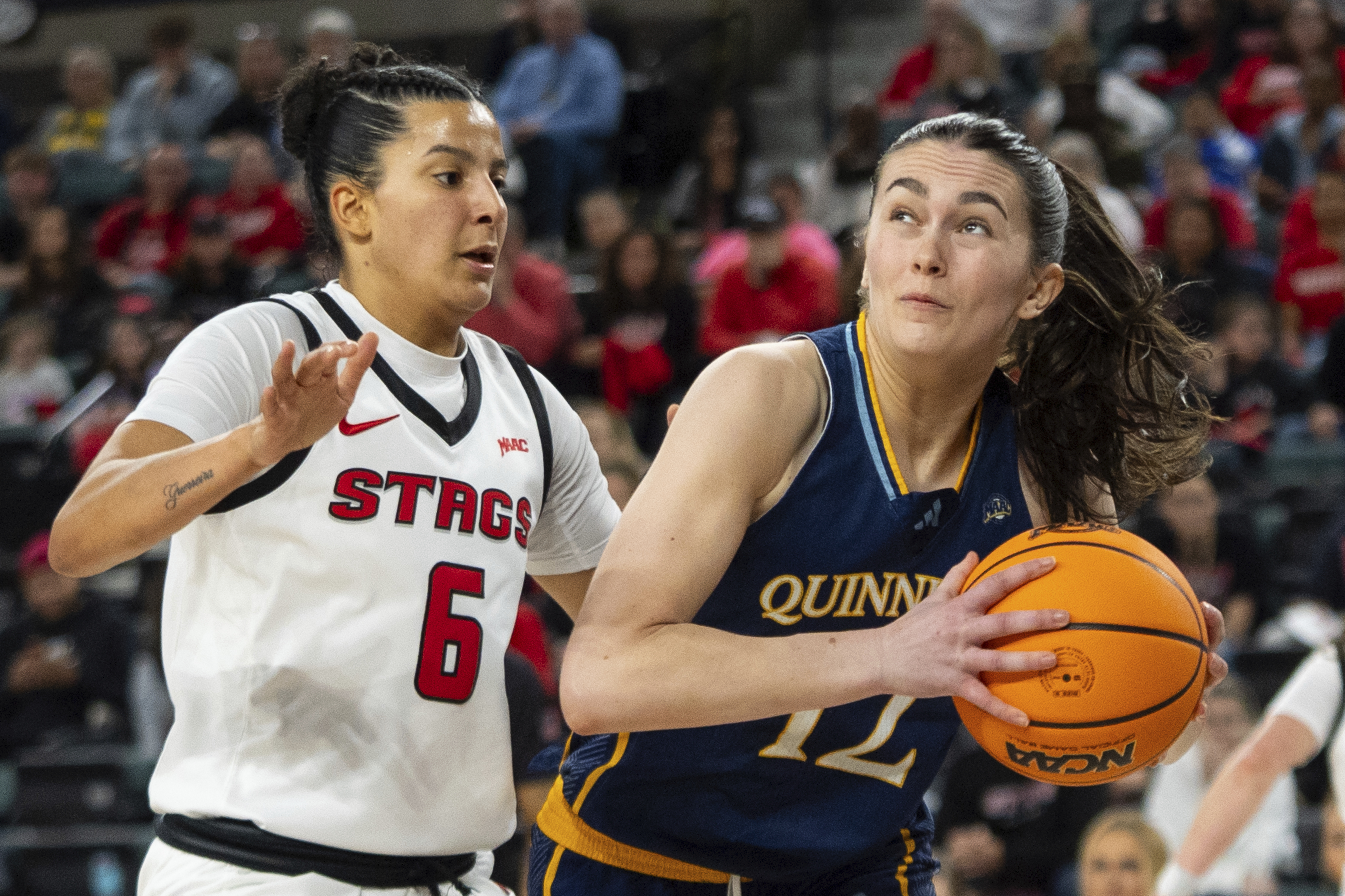 Quinnipiac's Ella O'Donnell, right, looks to shoot against Fairfield's Izabela Nicoletti Leite, left, during the first half of an NCAA college basketball game in the championship of the Metro Atlantic Athletic Conference tournament, Saturday, March 15, 2025, in Atlantic City, N.J.