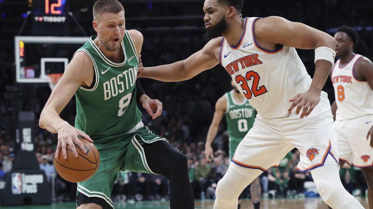 Boston Celtics' Kristaps Porzingis (8) looks to move against New York Knicks' Karl-Anthony Towns (32) during the second half of an NBA basketball game Sunday, Feb. 23, 2025, in Boston.