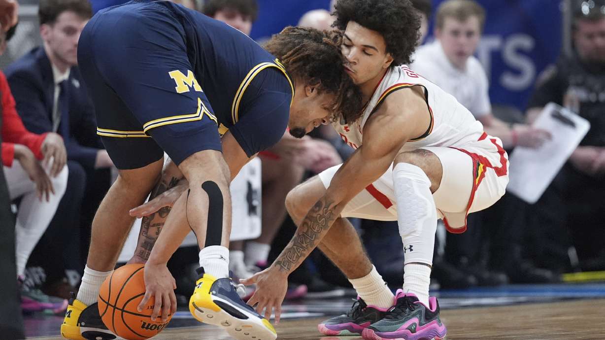 Michigan Wolverines guard Tre Donaldson (3) collects the ball as Maryland guard Ja'Kobi Gillespie (0) attempts a steal during the first half of an NCAA college basketball game in the semifinals of the Big Ten Conference tournament in Indianapolis, Saturday, March 15, 2025.