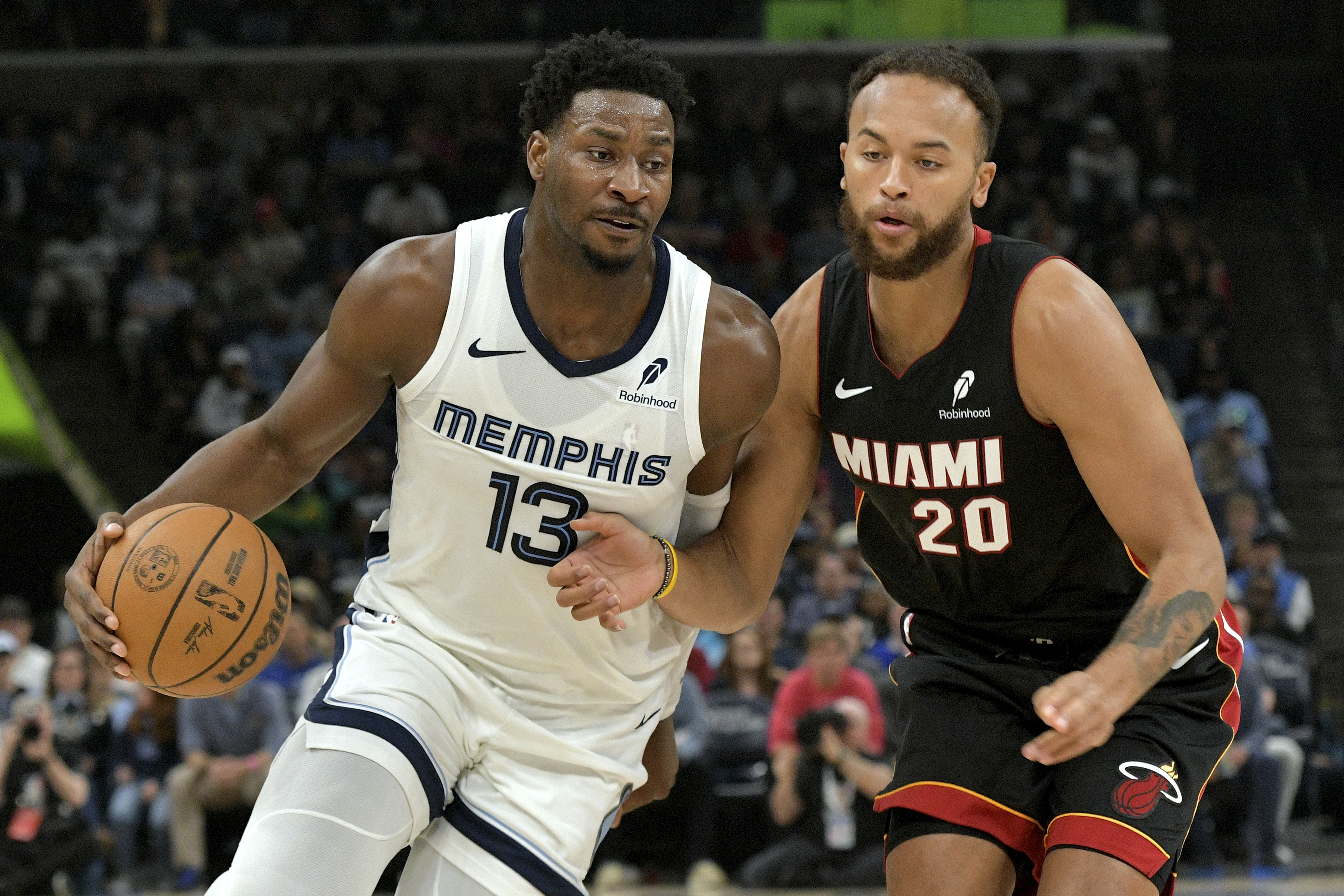 Memphis Grizzlies forward Jaren Jackson Jr. (13) handles the ball against Miami Heat forward Kyle Anderson (20) in the first half of an NBA basketball game Saturday, March 15, 2025, in Memphis, Tenn.