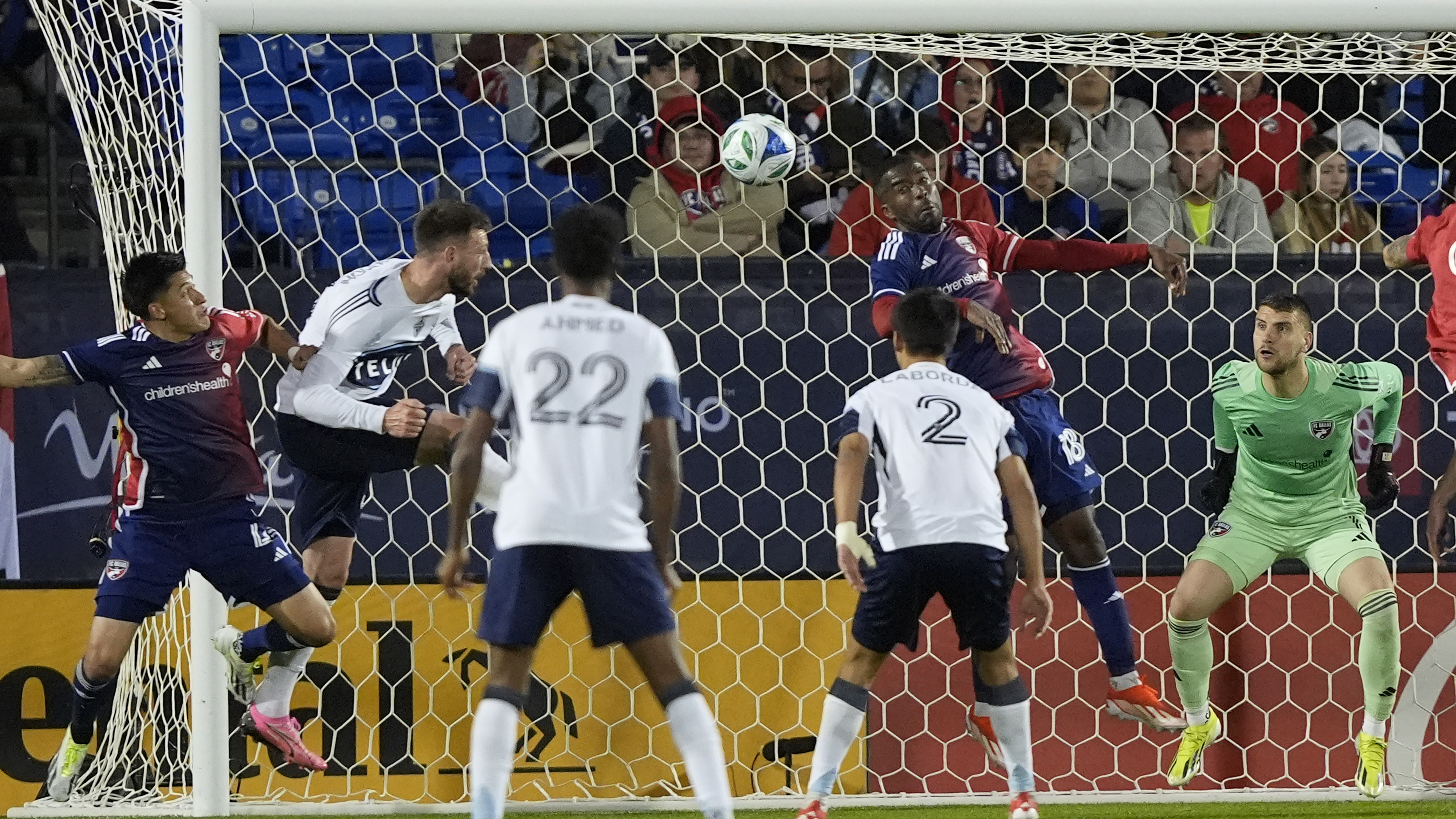Vancouver Whitecaps defender Tristan Blackmon, second from left, scores a goal against FC Dallas defenders Shaq Moore (18), Marco Farfan (4) and goalkeeper Maarten Paes (1) during second-half MLS soccer match action in Frisco, Texas, Saturday, March 15, 2025.