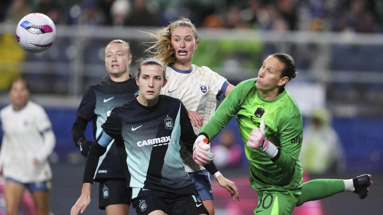 Seattle Reign FC forward Jordyn Huitema, back center, looks on with NJ/NY Gotham FC defender Tierna Davidson, left, as goalkeeper Ann-Katrin Berger (30) punches the ball away during the second half of an NWSL soccer match Saturday, March 15, 2025, in Seattle.
