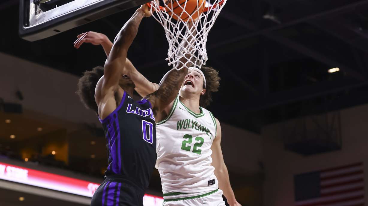 Grand Canyon guard Ray Harrison (0) dunks the ball under pressure from Utah Valley forward Carter Welling (22) during the first half of an NCAA college basketball game in the championship of the Western Athletic Conference tournament Saturday, March 15, 2025, in Las Vegas.
