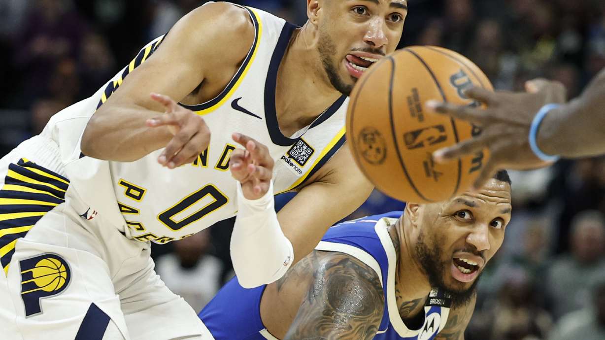 Indiana Pacers' Tyrese Haliburton (0) passes the ball against Milwaukee Bucks' Damian Lillard during the second half of an NBA basketball game Saturday, March 15, 2025, in Milwaukee.