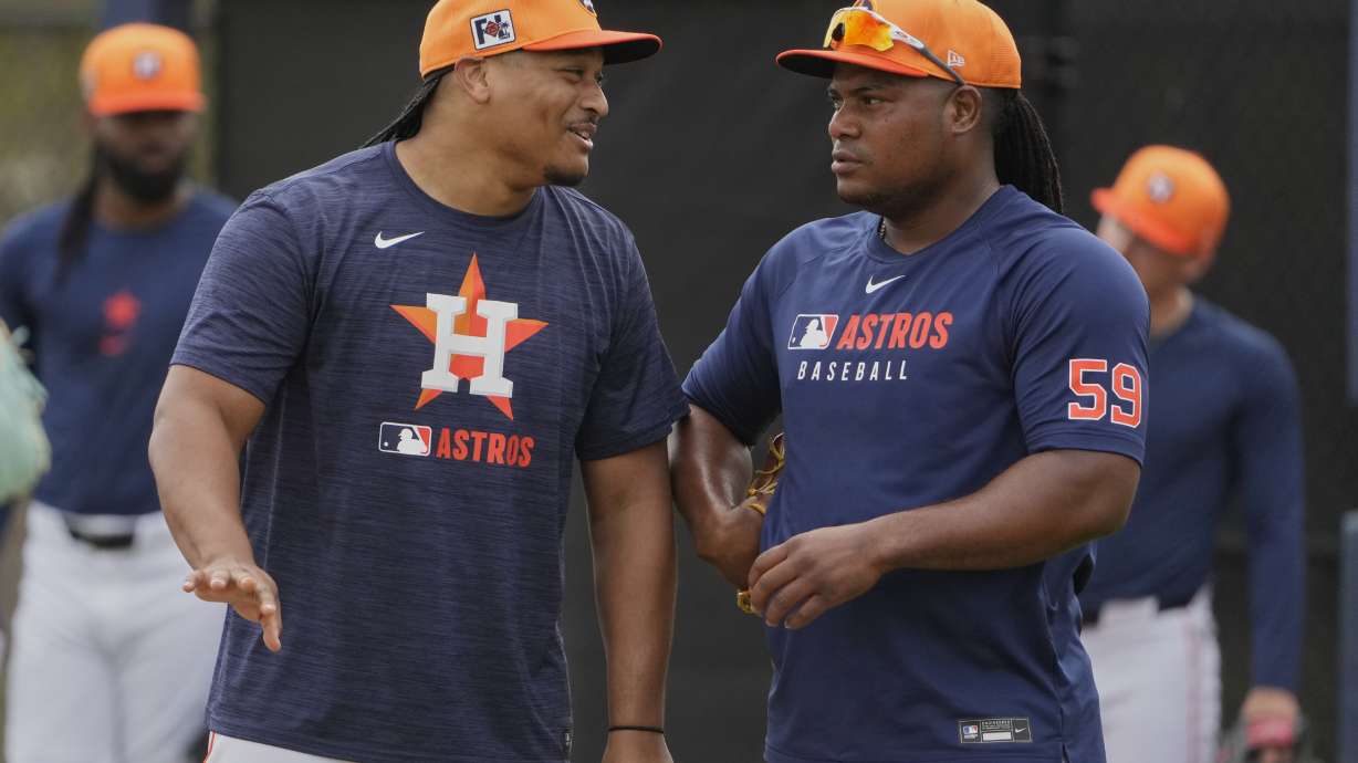 Houston Astros pitcher Luis Garcia, left, talks with fellow pitcher Framber Valdez (59) during a spring training baseball practice Sunday, Feb. 16, 2025, in West Palm Beach, Fla.