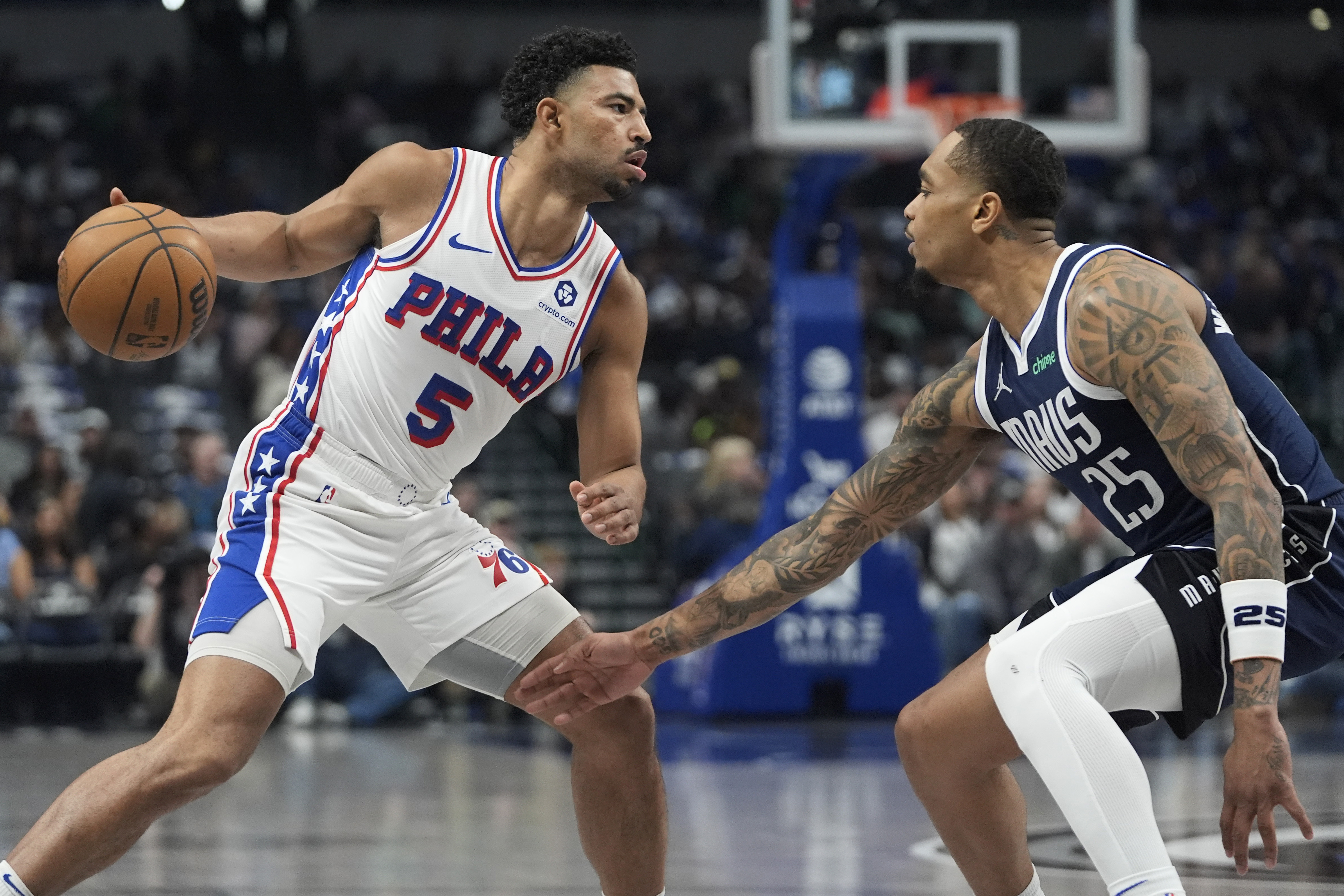 Philadelphia 76ers guard Quentin Grimes (5) dribbles against Dallas Mavericks forward P.J. Washington (25) during the first half of an NBA basketball game in Dallas, Sunday, March 16, 2025.