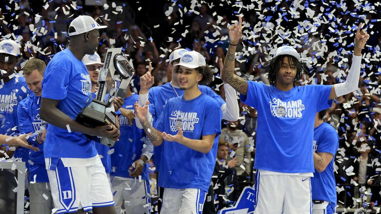 Duke celebrates with the trophy after their win against Louisville after an NCAA college basketball game in the championship of the Atlantic Coast Conference tournament, Saturday, March 15, 2025, in Charlotte, N.C.