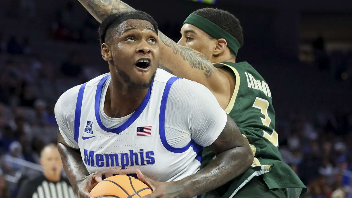 Memphis forward Dain Dainja, left, looks to shoot around UAB forward Yaxel Lendeborg, right, during the first half of an NCAA college basketball game in the championship of the American Athletic Conference tournament, Sunday, March 16, 2025, in Fort Worth, Texas.
