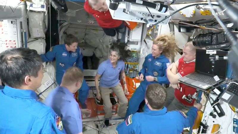 This image made from video by NASA shows astronauts, including Suni Williams, center, greeting each other after a SpaceX capsule docked with the International Space Station, Sunday.