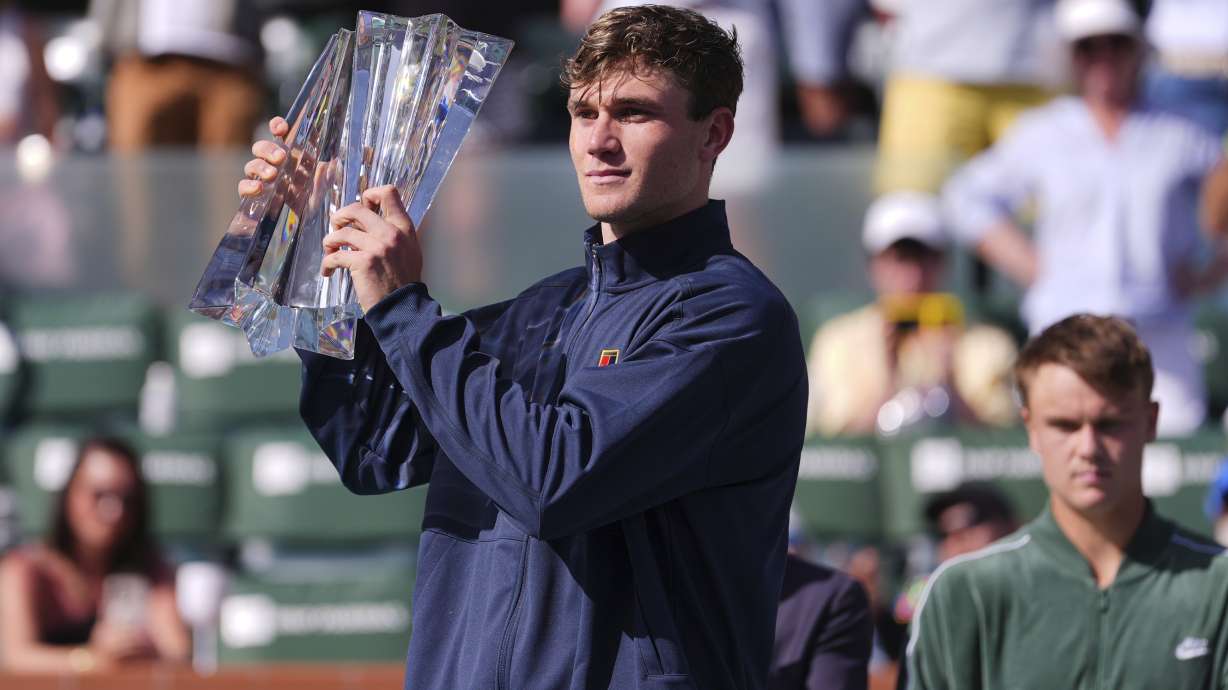 Jack Draper, of Britain, holds the winner's trophy at the BNP Paribas Open tennis tournament Sunday, March 16, 2025, in Indian Wells, Calif.
