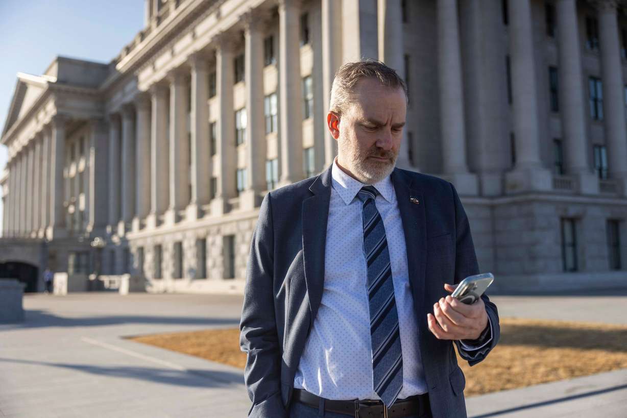 State Sen. Lincoln Fillmore, R-South Jordan, attends a Senate Judiciary Committee meeting on his phone while waiting to have his picture taken after an interview with the Deseret News, at the Capitol in Salt Lake City on Feb. 28.